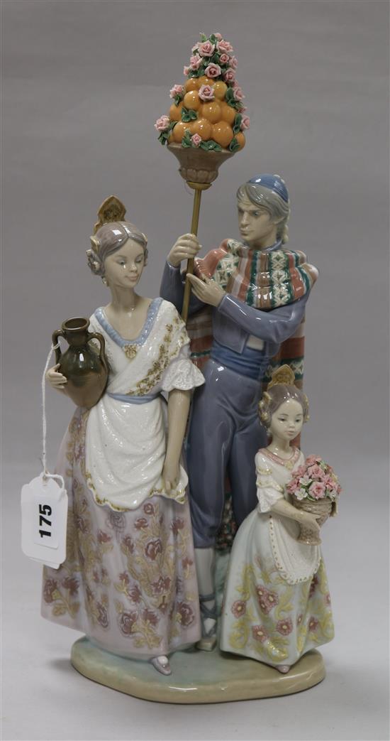 A Lladro group of Valencian figures with oranges and roses